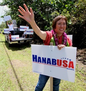 Rep. Colleen Hanabusa signwaves on Kahakai Blvd on Friday (Aug 15) in Puna on the morning of the delayed primary election for two Puna precincts. Photography by Baron Sekiya | Hawaii 24/7