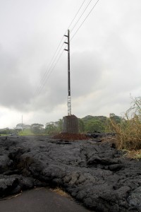 A HELCO utility pole which was hardened against the onslaught of the lava flow appears to be surviving in the lava flow Saturday (Oct 25). Photo courtesy of HELCO