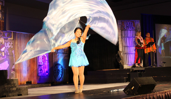 Ariel Enriquez performs a flag dance during the 2015 Miss Kona Coffee Scholarship Pageant. (Hawaii 24/7 photo by Karin Stanton)