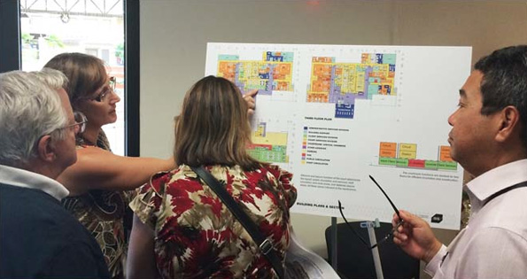 Deputy Chief Court Administrator Dawn West points out the public areas on the plan for the second level of the proposed court complex to Kailua Kona Public Defender Ann Datta, Attorney (retired) Fred Gianini, and (far right) Attorney Robert Kim. (Photo courtesy of Mike Kim | Architects Hawaii)