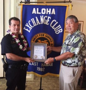 Aloha Exchange board member Curtis Chong presents an 'Officer of the Month' award to Officer Mark Arnold.