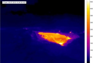 This thermal image of the Puʻu ʻŌʻō crater, sent by text on May 7, 2015, to USGS Hawaiian Volcano Observatory geologists, is an example of the thermal camera alarm system developed at HVO. In this case, the alarm was triggered by the appearance of new lava on the floor of Puʻu ʻŌʻō, seen here as the brightly colored (hot) region in the image. The temperature scale at right is in degrees Celsius. USGS webcam image.