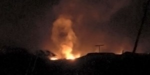 The harvested eucalyptus log storage facility at Kawaihae ablaze Saturday night (Aug 8). Photo Special to Hawaii 24/7 by Jessica Ferracane