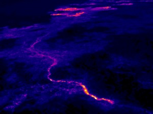 The breakout that began in late November continues to feed lava to the northern boundary of the flow field via a new lava tube. The trace of this new tube is easily visible in the thermal images. This view looks northeast, and the breakouts along the forest boundary are visible near the top edge of the photograph. Photo taken Wednesday, December 30, 2015 courtesy of USGS/HVO