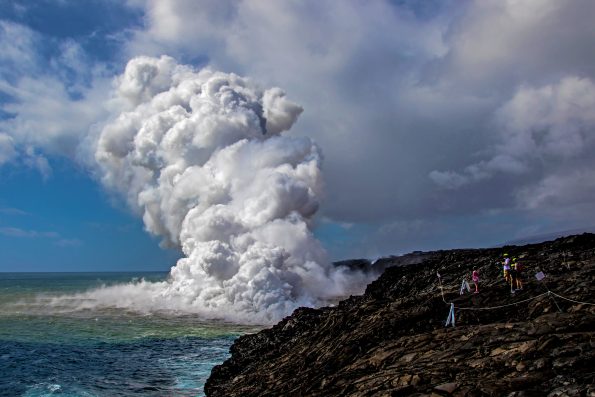 A large plume of rock debris and gas emanates from the Kamokuna lava ocean entry within Hawaii Volcanoes National Park, just moments after the lava delta began to collapse. NPS Photo