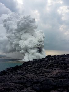 A large plume of rock debris and gas emanates from the Kamokuna lava ocean entry within Hawaii Volcanoes National Park, just moments after the lava delta began to collapse. NPS Photo/Travis Delimont