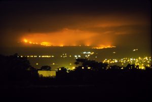 Glow from a Mauna Loa lava flow lit up the night sky above Hilo on April 4, 1984. In this photo, captured from near the Hilo airport, the flow front appears closer to the city than it actually was. Should a similar eruption occur in the future, the U.S. Geological Survey’s lava flow inundation maps could help alleviate concern for residents outside the identified inundation zone for a given flow. Photo courtesy of David Little.