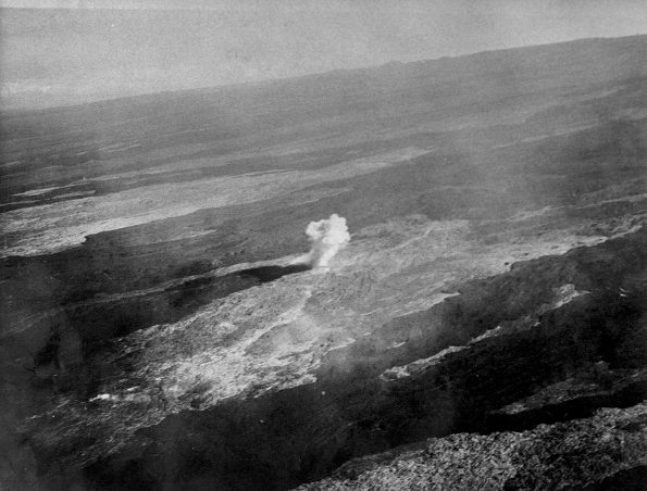 Aerial view of a bomb detonating on Mauna Loa near the 8500-foot elevation source of the 1935 lava flow on the morning of December 27, 1935. This was one of twenty 600-pound bombs dropped on the lava flow that morning by the Army Bombing Squadron from Luke Field, O‘ahu. Photo by Army Air Corps, 11th Photo Section.