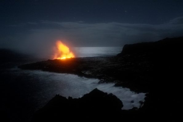 Glow from an active ocean entry on Kīlauea Volcano’s Kamokuna lava delta was visible on the evening of September 27, when the 2017 delta was near its maximum size of 8-10 acres. Since then, the edges of the delta began to crumble into the sea. With no lava entering the ocean since November, ocean waves slowly erode the lava delta, further reducing its size. USGS image.
