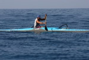 Jackie Rey’s Relay Canoe Race first place finisher, Kua Nolan on his V-1 Rudderless Canoe. Kua completed the 12 mile course in 1:56:02 as an “Iron” paddler, meaning he chose not to tag off a partner at Kailua Pier, but to paddle the entire distance solo. Photo by Susan Anderson