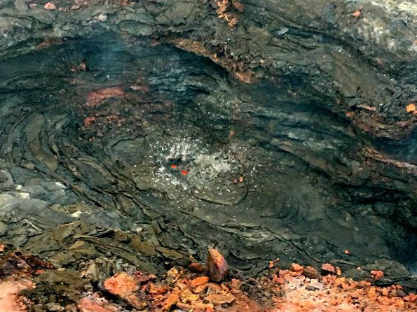 This morning, USGS scientists flying over fissure 8 noticed a change in the vent from yesterday. Gas jets were throwing spatter—fragments of glassy lava (light gray deposits)—from small incandescent areas deep within the cone. This activity is an indication that the lower East Rift Zone eruption may be paused rather than pau (over). Photo taken Monday, August 20, 2018 courtesy of U.S. Geological Survey