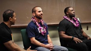 HIP co-director Ken Lawson, at left, with mainland exonerates Uriah Courtney, middle, and Brian Banks in 2017 at the law school.