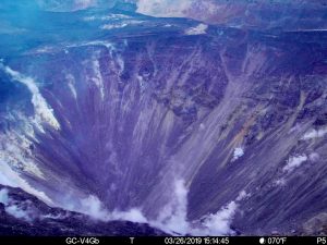 This image was taken at 3:14 p.m., Tuesday, March 26, 2019, from a camera on the west rim of Kilauea Caldera. The camera is looking East towards the bottom of the newly enlarged HalemaÊ»umaÊ»u crater, although the deepest part of the crater is not visible from this vantage point. The crater from left to right (roughly NNE to SSW) is approximately 1 km (0.6 mi) across. The depth of the crater in the visible image from the rim is several hundred meters. Photo from USGS/HVO