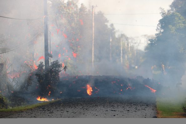 The start of fissure 3 during KÄ«laueaâ€™s lower East Rift Zone eruption. Lava erupting to the surface cut across Kaupili Street around 7:00 a.m. on May 4, 2018. USGS photo by M. Patrick.