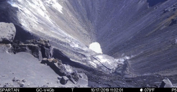This image is from a temporary monitoring camera on the west rim of Kilauea Caldera. The camera is looking E towards the bottom of the newly enlarged Halemaʻumaʻu crater. The crater from left to right (roughly NNE to SSW) is approximately 1 km (0.6 mi) across. The depth of the crater in the visible image from the rim is several hundred meters.